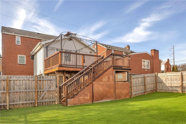 back of property with a yard, a gazebo, and a deck