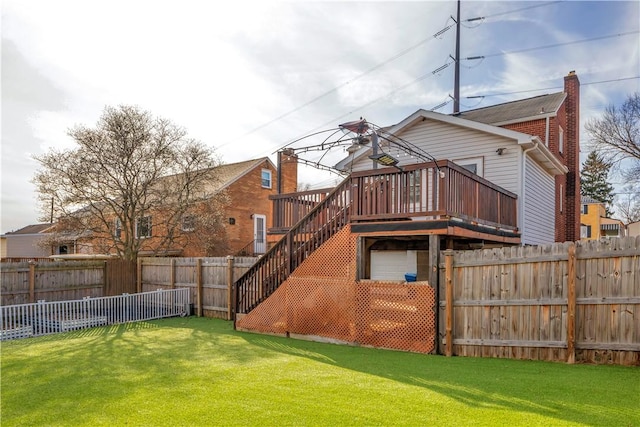 back of house with a deck and a lawn