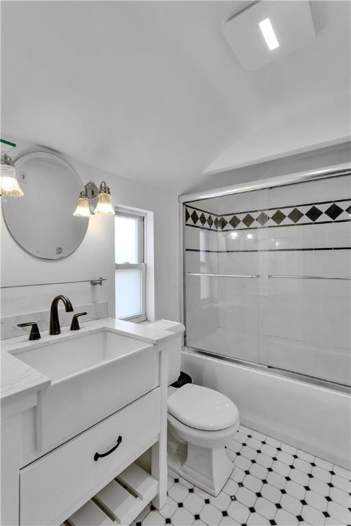 full bathroom with vanity, combined bath / shower with glass door, and toilet