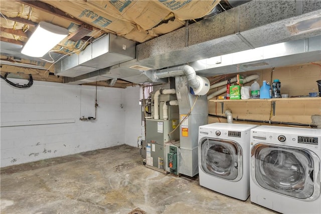 basement with heating unit and washer and dryer