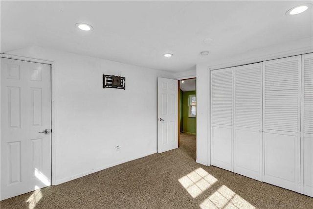 unfurnished bedroom featuring carpet flooring and a closet