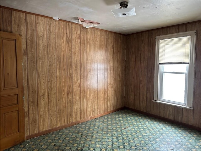 spare room with wood walls