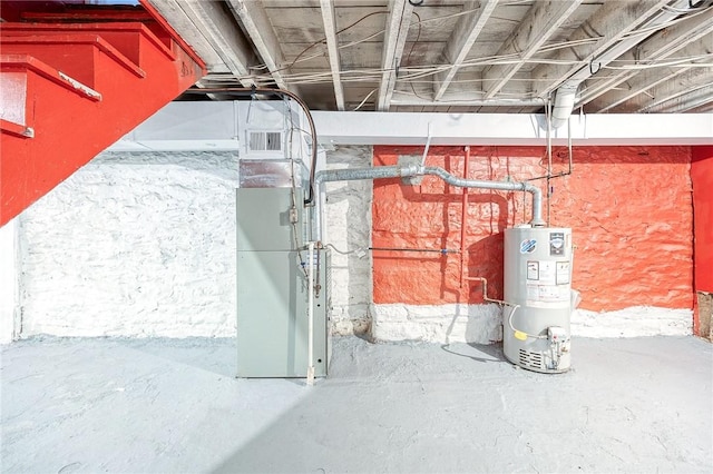 basement featuring heating unit and gas water heater