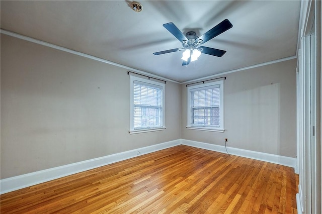 spare room featuring ceiling fan, ornamental molding, and light hardwood / wood-style flooring