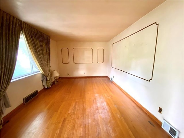 spare room featuring light wood-type flooring