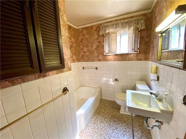 bathroom with crown molding, sink, a bath, and toilet