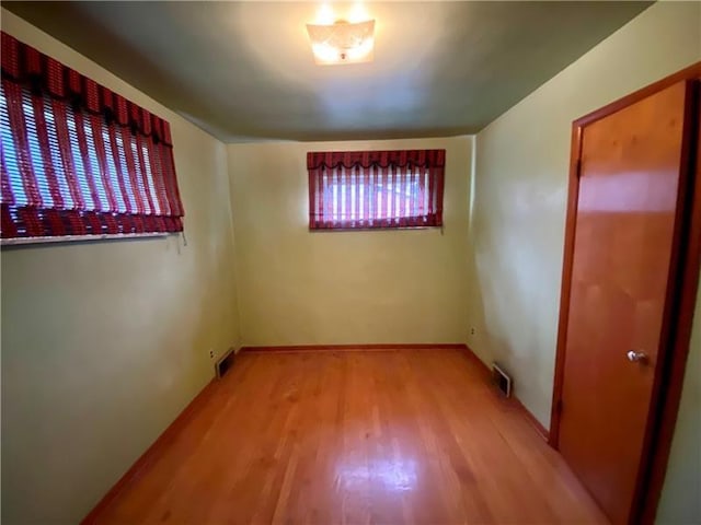 unfurnished room with light wood-type flooring