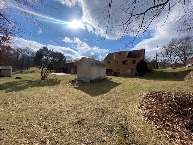 view of side of property featuring a shed and a lawn