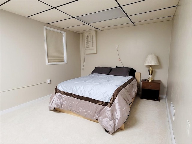 bedroom featuring carpet flooring and a paneled ceiling