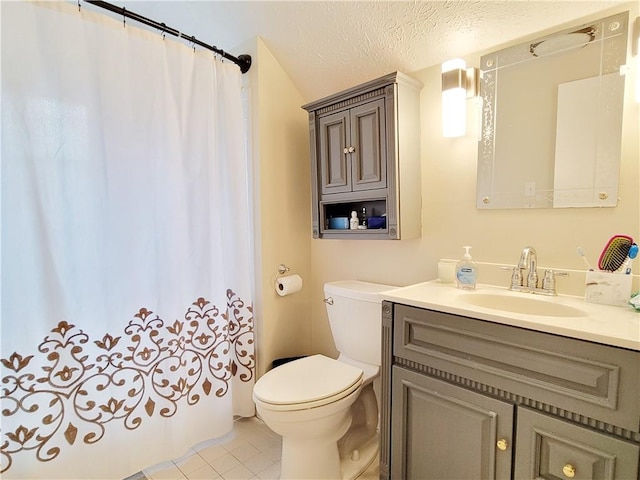 bathroom with vanity, tile patterned floors, toilet, and a textured ceiling