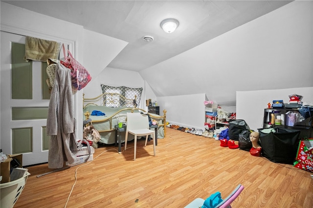 playroom with lofted ceiling and wood-type flooring