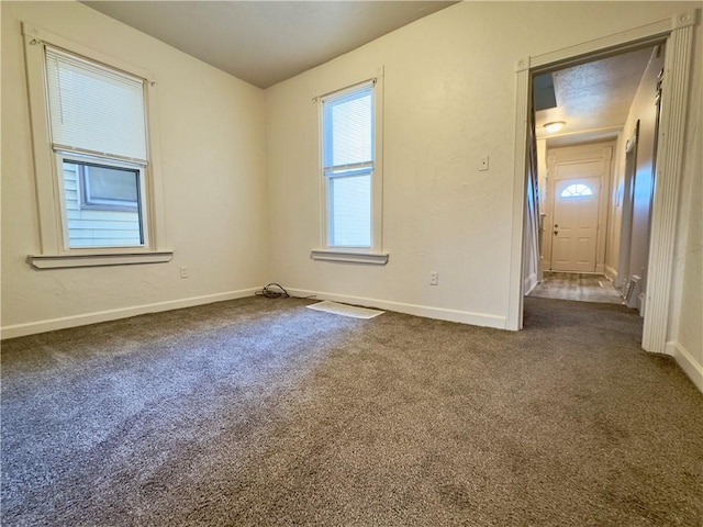 unfurnished bedroom with carpet flooring and baseboards