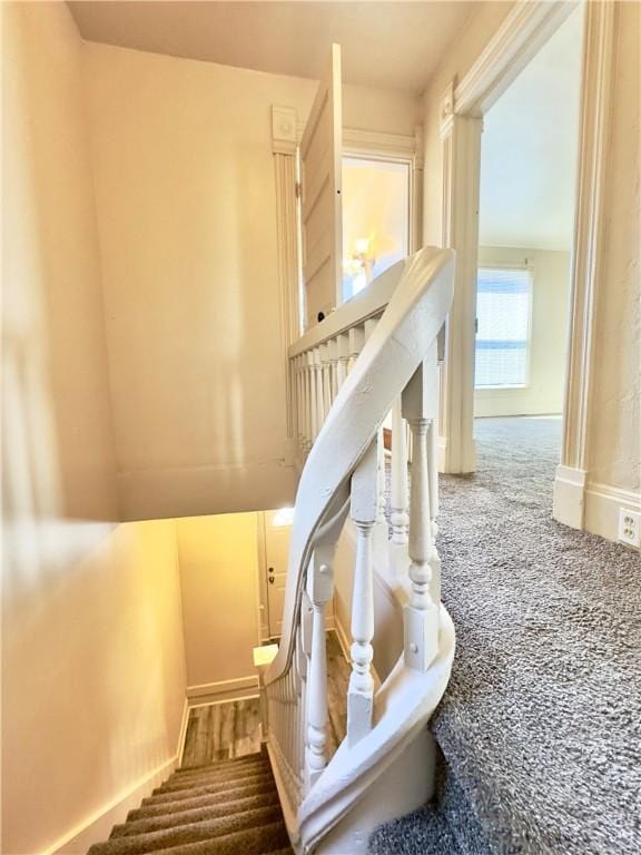 staircase featuring baseboards