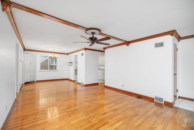 unfurnished living room featuring crown molding, ceiling fan with notable chandelier, and light hardwood / wood-style floors