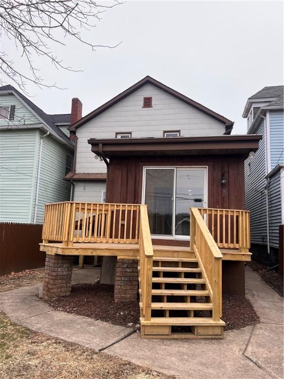 rear view of property featuring a deck