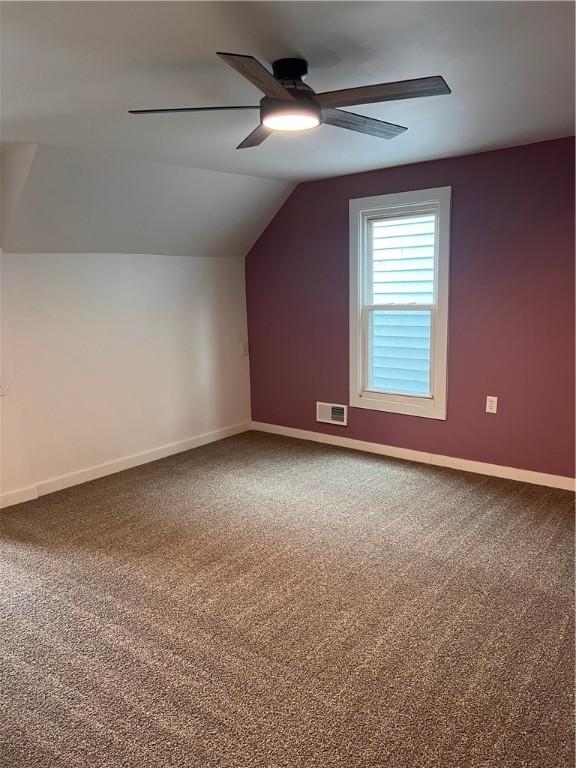 bonus room with ceiling fan, lofted ceiling, and carpet flooring