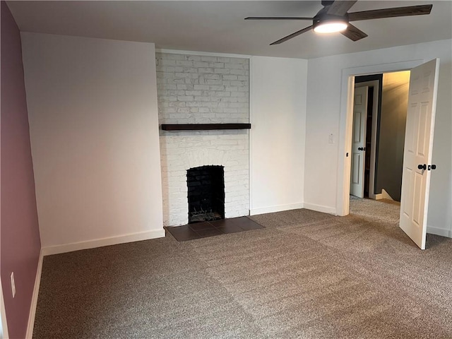 unfurnished living room featuring ceiling fan, a brick fireplace, and dark colored carpet