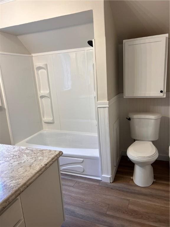 full bathroom featuring vanity, wood-type flooring, toilet, and washtub / shower combination