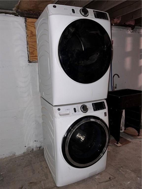 laundry area with stacked washer / drying machine