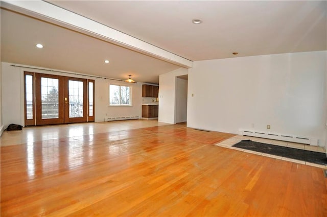 unfurnished living room with baseboard heating, lofted ceiling with beams, french doors, and light wood-type flooring