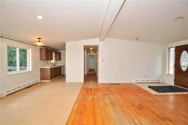 entryway featuring baseboard heating, sink, and lofted ceiling with beams