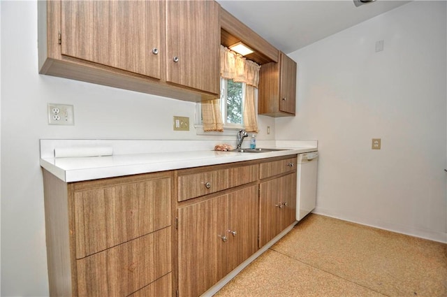 kitchen featuring white dishwasher and sink