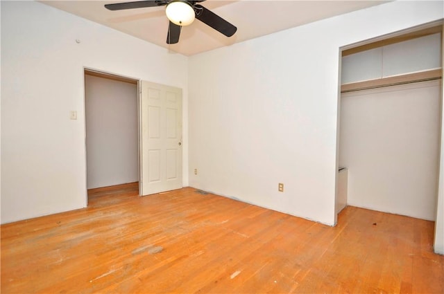 unfurnished bedroom with wood-type flooring, a closet, and ceiling fan