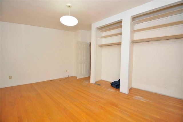 unfurnished bedroom with hardwood / wood-style flooring