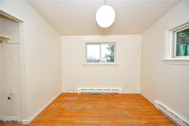 spare room featuring plenty of natural light, light hardwood / wood-style floors, and baseboard heating