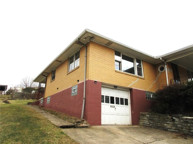 view of side of property with a garage and a yard