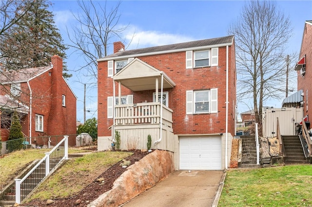 view of front of house featuring a garage and a front lawn