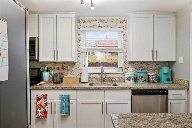 kitchen featuring white cabinetry, appliances with stainless steel finishes, and sink