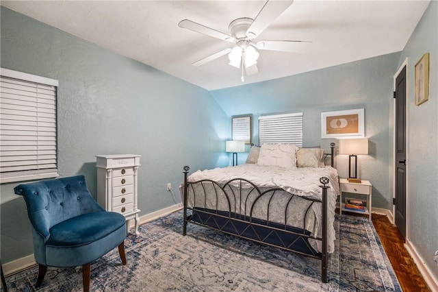 bedroom with lofted ceiling, dark wood-type flooring, and ceiling fan