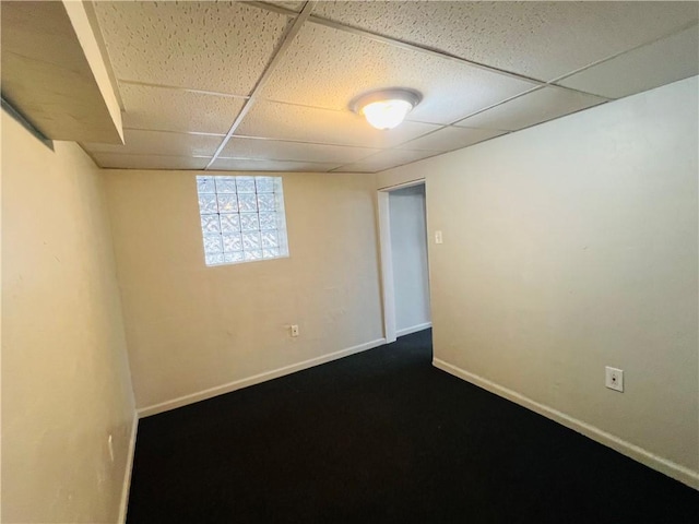 basement featuring a paneled ceiling