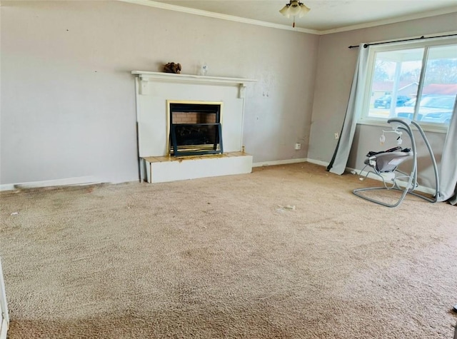 unfurnished living room with crown molding, ceiling fan, and carpet floors