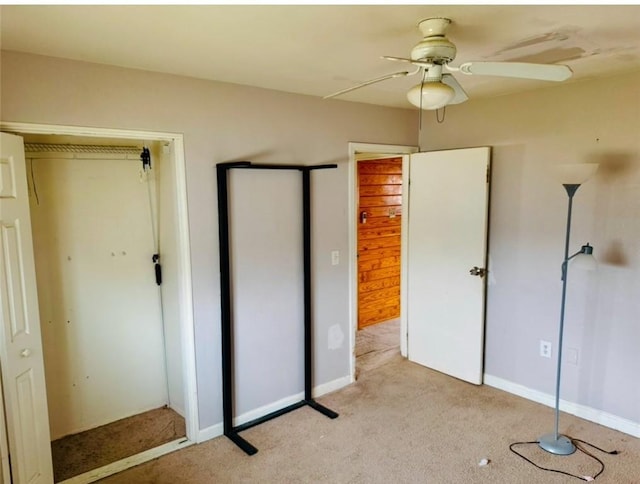 unfurnished bedroom with light colored carpet and ceiling fan