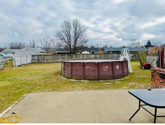 view of yard with a fenced in pool and a patio area