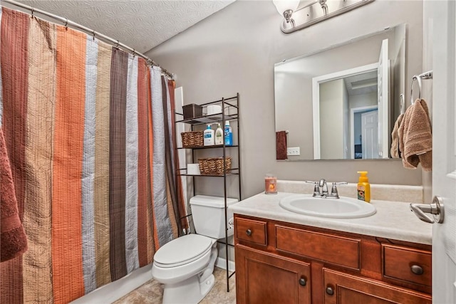 bathroom with vanity, a textured ceiling, and toilet