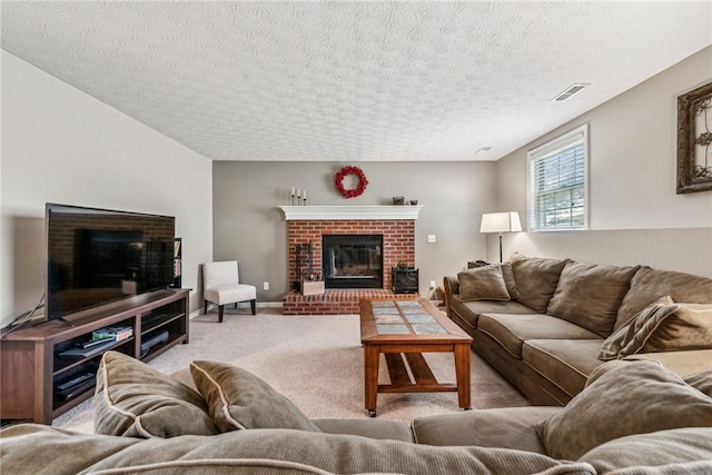 carpeted living room with a brick fireplace and a textured ceiling