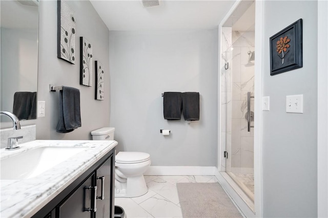 bathroom with vanity, toilet, and a shower with shower door