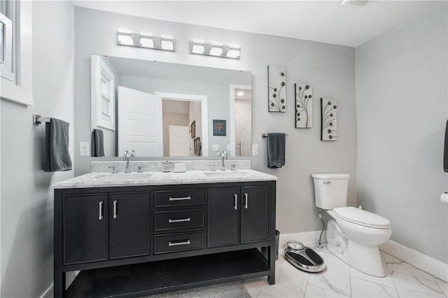 bathroom with vanity, toilet, and a shower