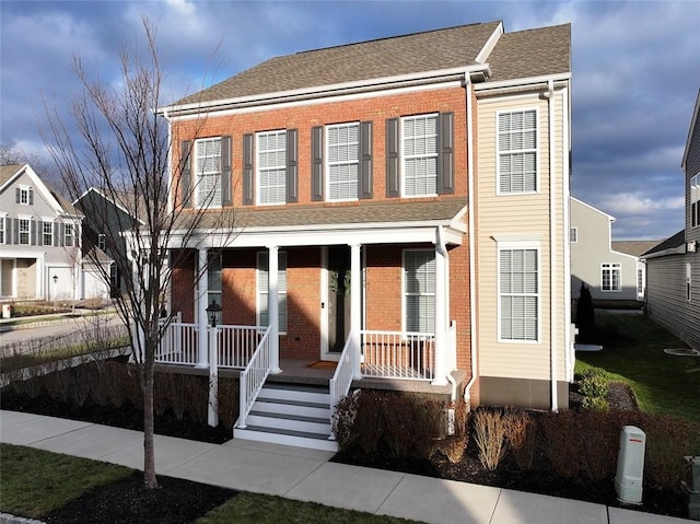 townhome / multi-family property featuring covered porch