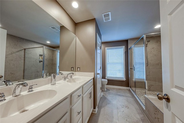 bathroom with vanity, an enclosed shower, and toilet