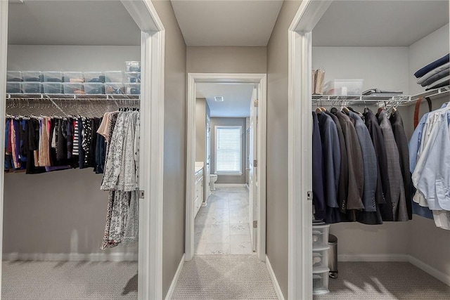 walk in closet featuring carpet