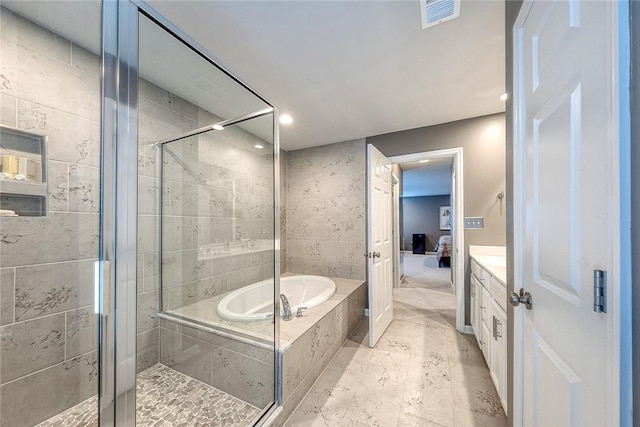 bathroom with vanity and separate shower and tub