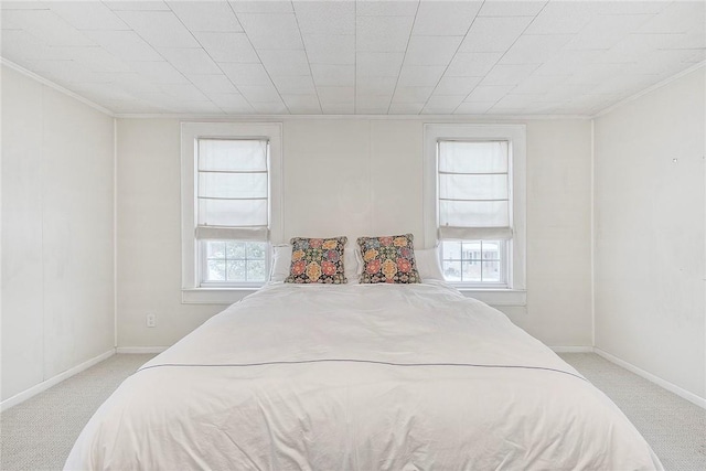 bedroom with multiple windows, ornamental molding, and light carpet