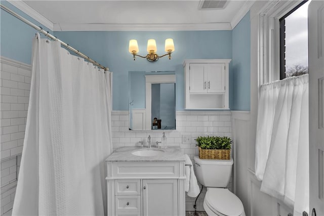 bathroom featuring ornamental molding, tile walls, vanity, and toilet