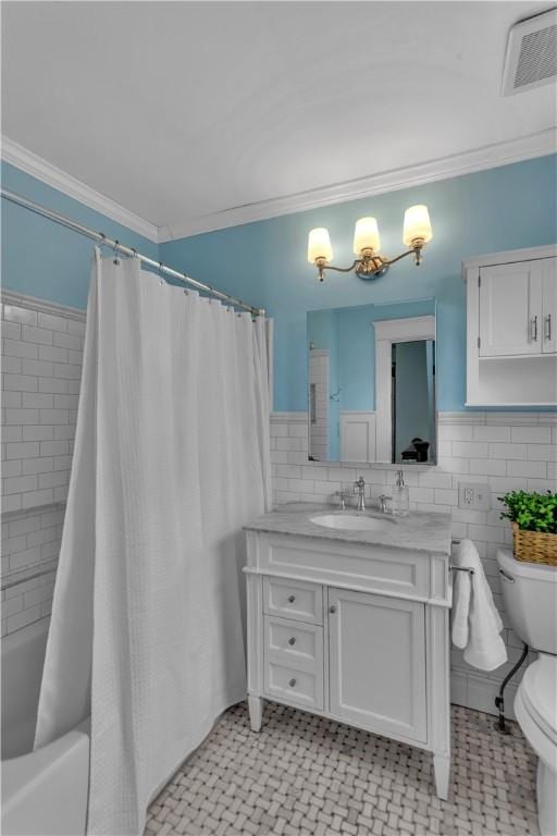 full bathroom featuring shower / tub combo with curtain, crown molding, tile walls, vanity, and toilet