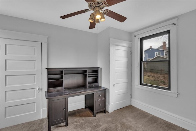 home office with dark carpet and ceiling fan