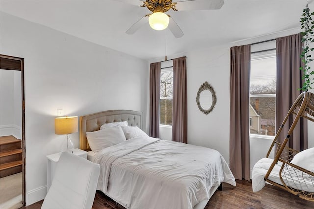 bedroom with dark hardwood / wood-style floors and ceiling fan